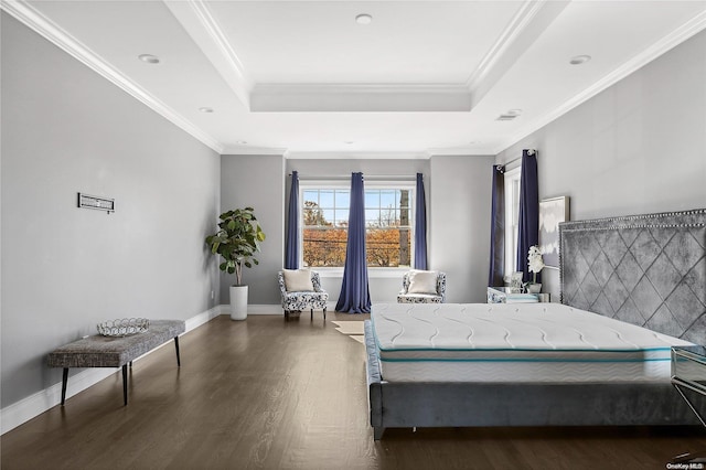 bedroom with crown molding, a tray ceiling, and dark hardwood / wood-style flooring