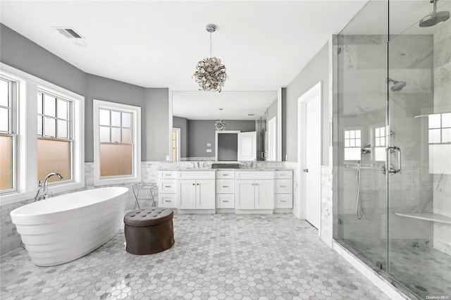 bathroom featuring separate shower and tub, tile patterned flooring, vanity, and tile walls