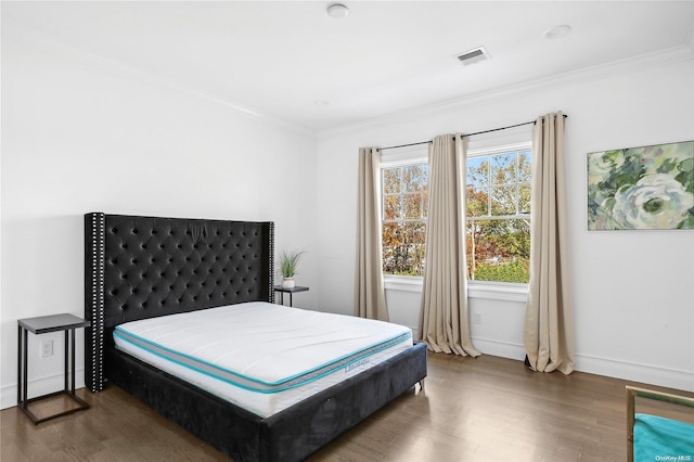 bedroom featuring dark wood-type flooring and ornamental molding