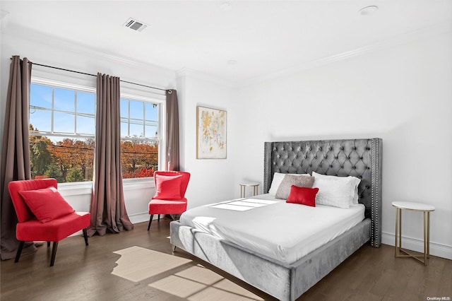 bedroom with dark hardwood / wood-style flooring and crown molding