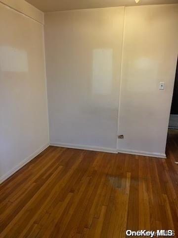 spare room featuring dark hardwood / wood-style flooring