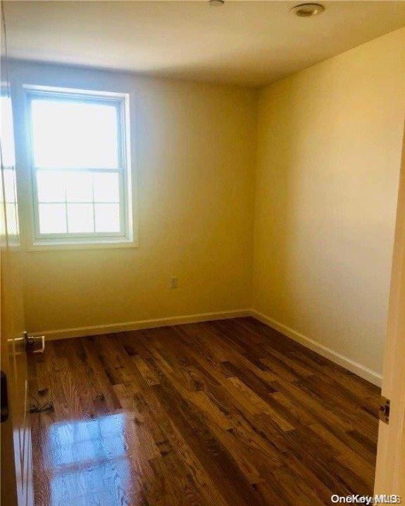 empty room featuring dark hardwood / wood-style floors