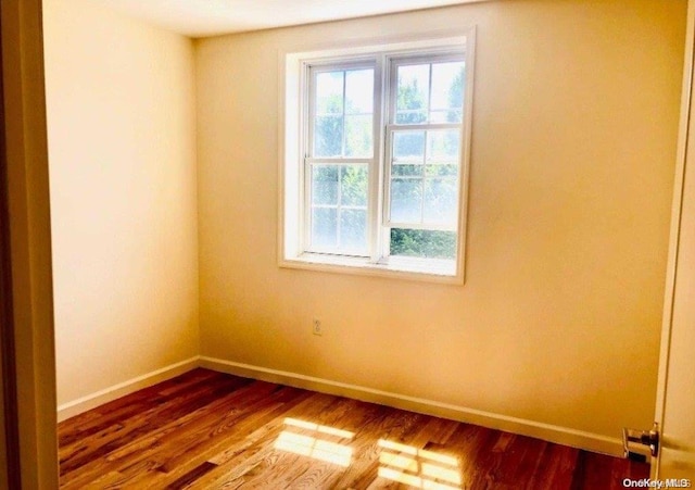 unfurnished room featuring hardwood / wood-style floors