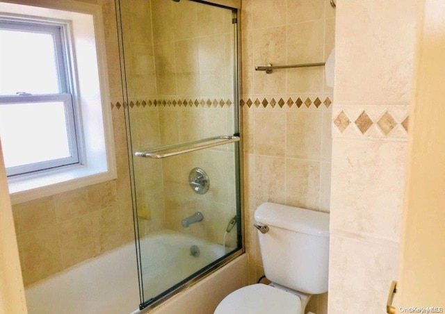 bathroom with toilet and enclosed tub / shower combo