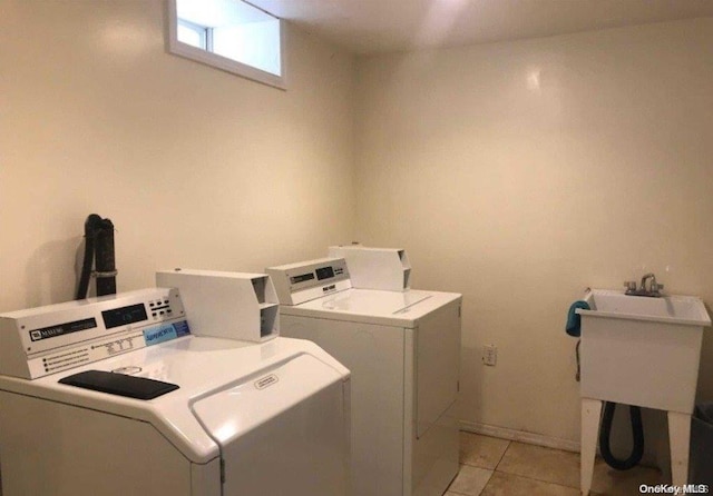 laundry area featuring separate washer and dryer and light tile patterned floors