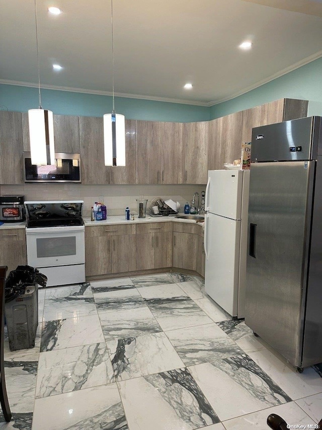 kitchen with sink, ornamental molding, hanging light fixtures, and appliances with stainless steel finishes