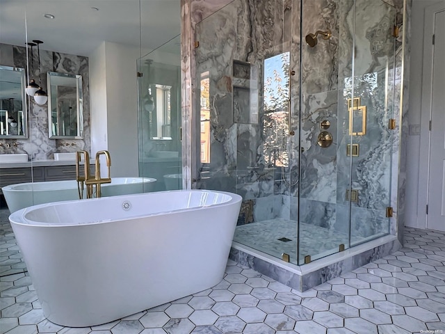 bathroom featuring tile patterned flooring, vanity, tile walls, and shower with separate bathtub