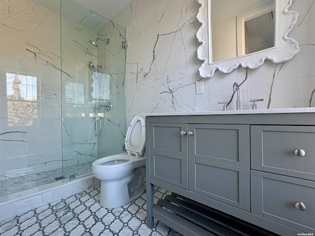 bathroom featuring vanity, toilet, and a shower with door