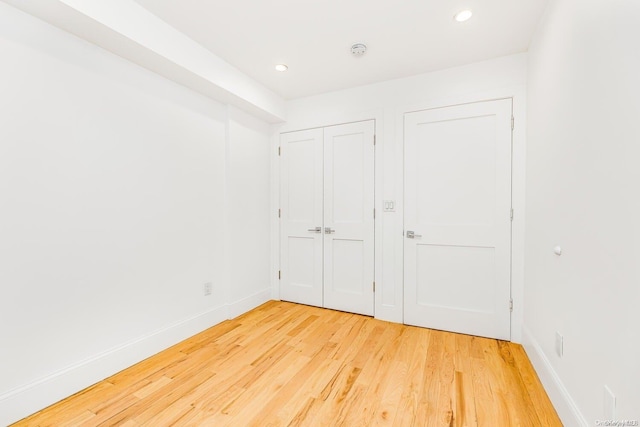 unfurnished bedroom with hardwood / wood-style flooring