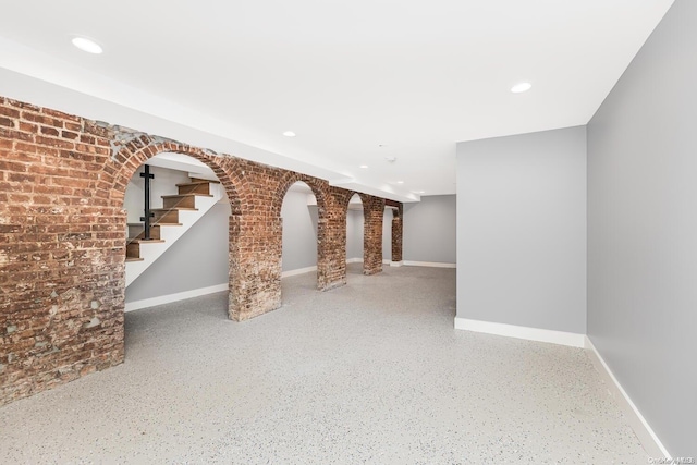 basement featuring brick wall