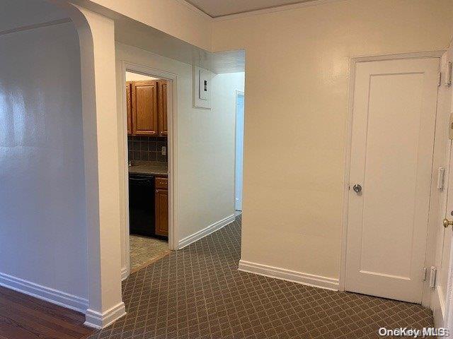 hallway featuring dark tile patterned flooring