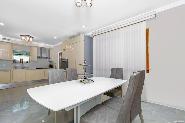 dining area featuring crown molding and sink