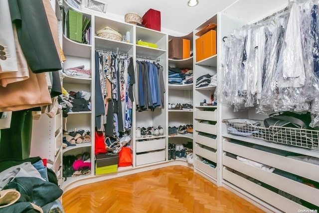 walk in closet featuring parquet floors