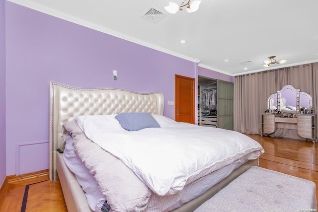 bedroom with light wood-type flooring, ornamental molding, and a closet