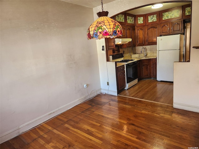 kitchen featuring dark wood-type flooring and white appliances