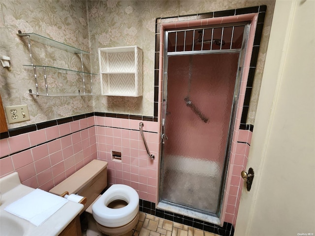 bathroom featuring toilet, tile walls, and walk in shower