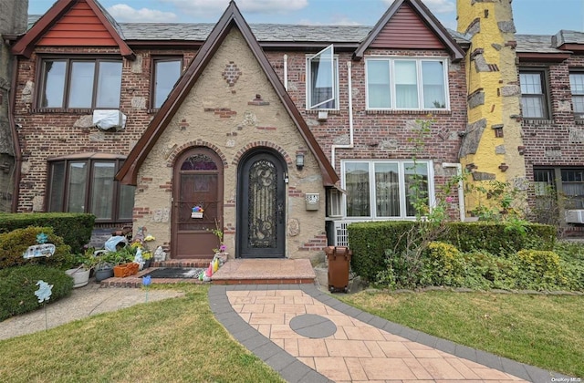 tudor-style house with a front yard