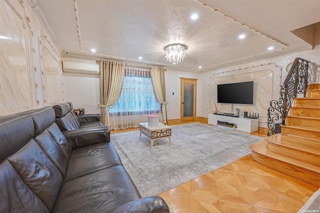 living room with crown molding, parquet floors, a notable chandelier, and a wall mounted air conditioner