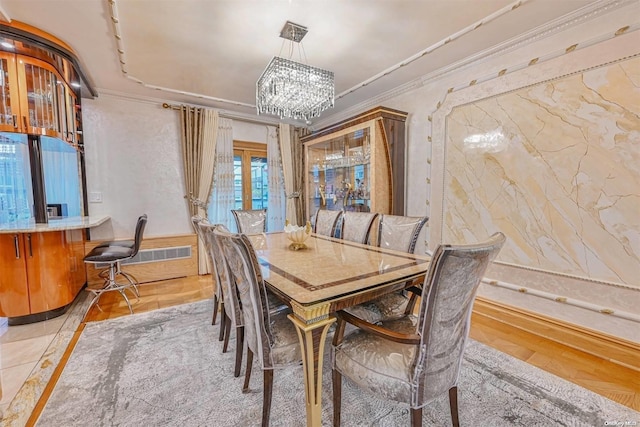 dining room featuring crown molding and a notable chandelier