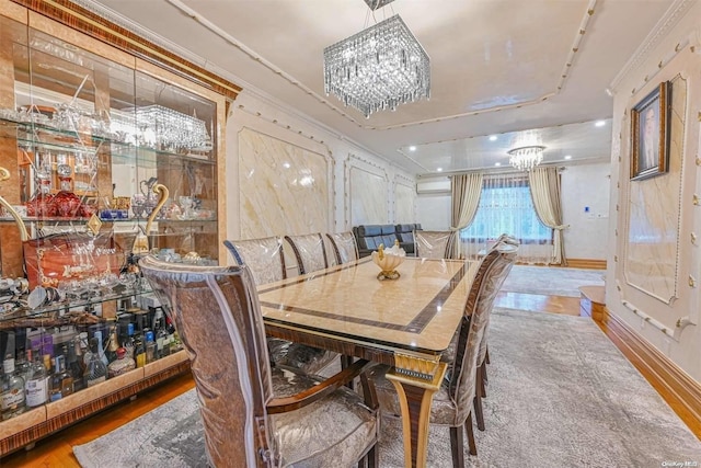 dining room with wood-type flooring, a chandelier, and ornamental molding