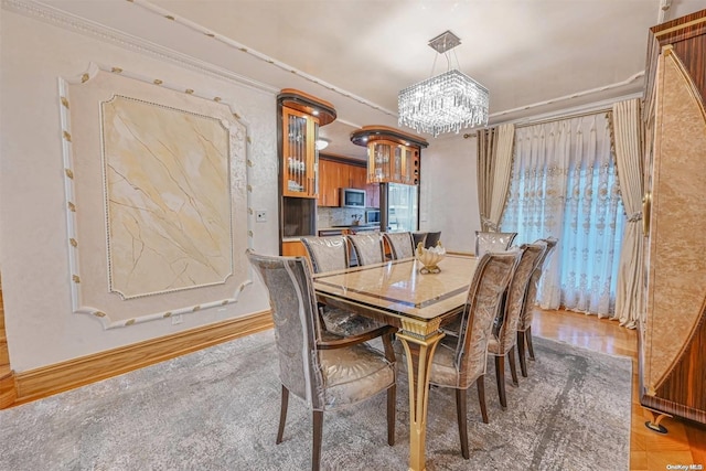 dining room featuring crown molding and a notable chandelier