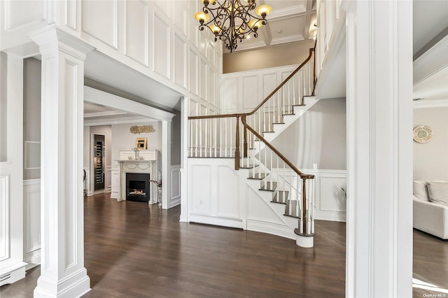 entryway featuring a chandelier, crown molding, dark hardwood / wood-style flooring, and a baseboard radiator