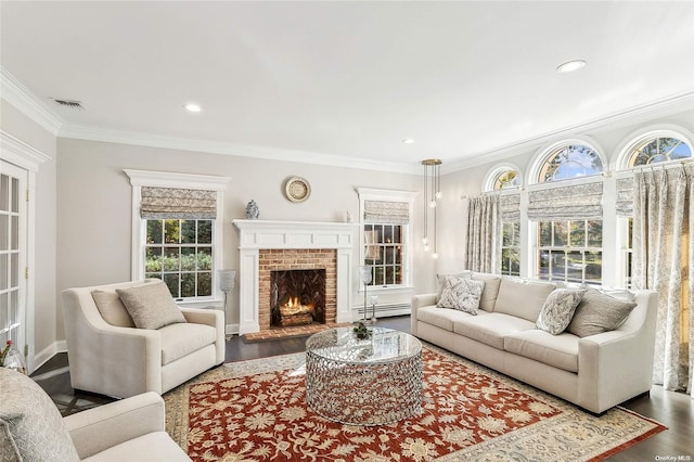 living room featuring hardwood / wood-style floors, a brick fireplace, baseboard heating, and crown molding