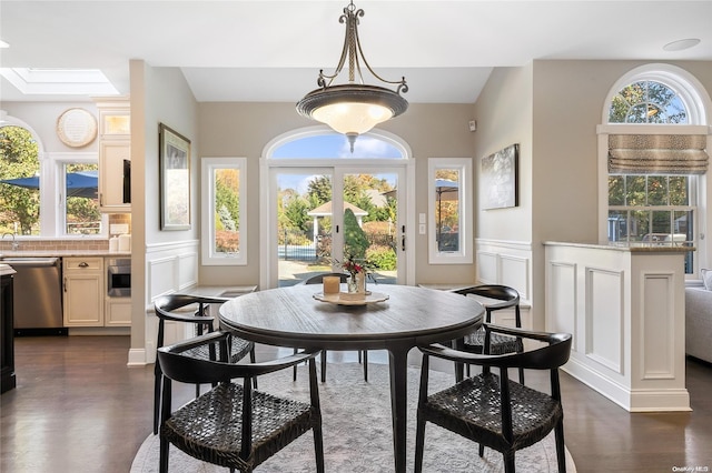 dining room with dark wood-type flooring and french doors