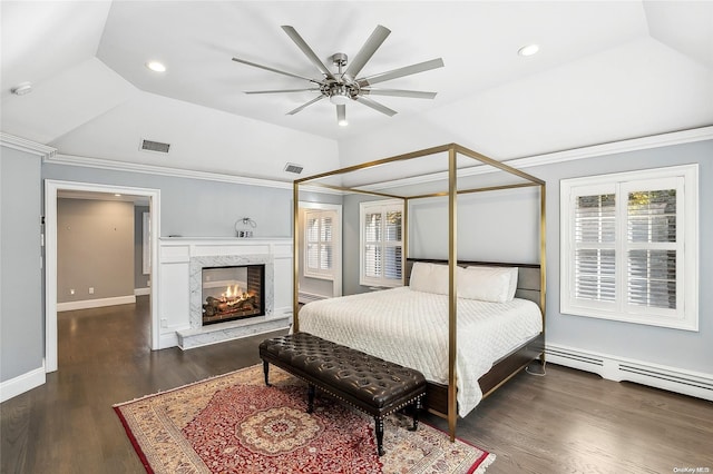 bedroom featuring lofted ceiling, ceiling fan, dark hardwood / wood-style floors, and a baseboard heating unit