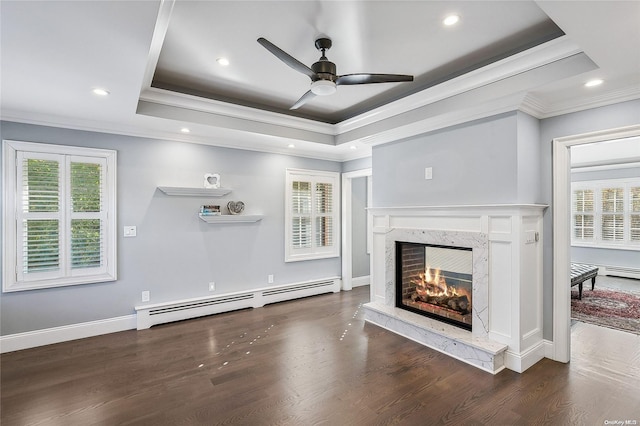 unfurnished living room featuring a raised ceiling, a premium fireplace, dark wood-type flooring, and a baseboard heating unit