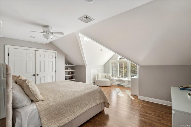 bedroom featuring dark hardwood / wood-style flooring, a closet, vaulted ceiling, and ceiling fan