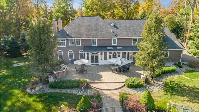 rear view of house with a patio area and a yard