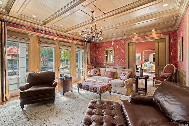 living room with hardwood / wood-style floors, wooden ceiling, french doors, ornamental molding, and a notable chandelier