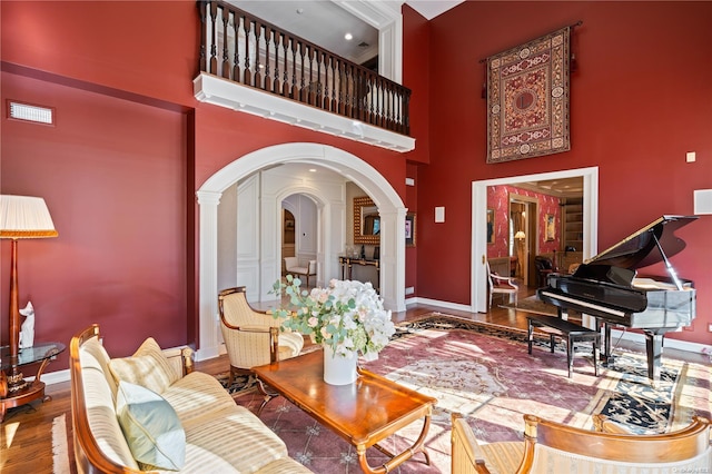 living room featuring hardwood / wood-style floors and a high ceiling