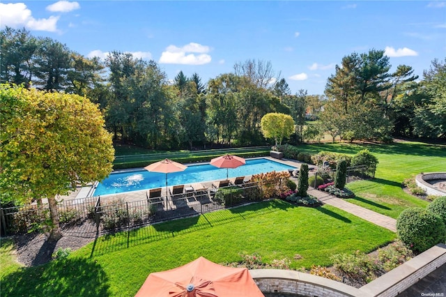 view of pool featuring a yard