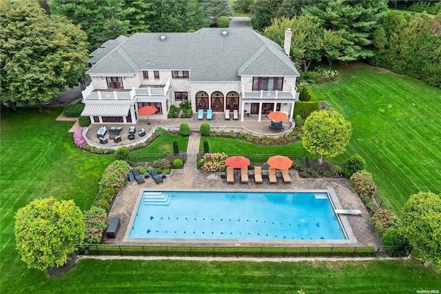 back of property with a lawn and a patio