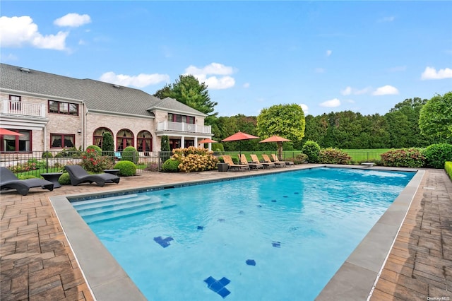 view of swimming pool featuring a patio area