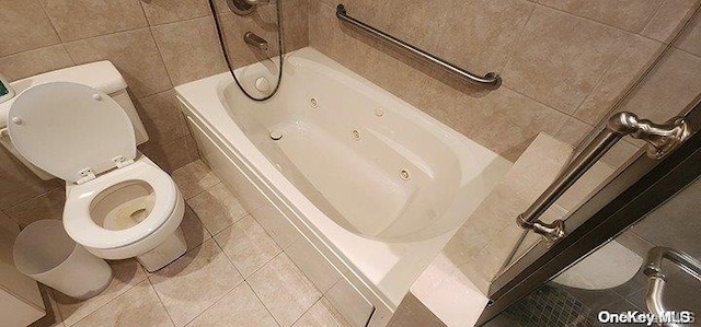 bathroom featuring tile patterned flooring, tile walls, and toilet