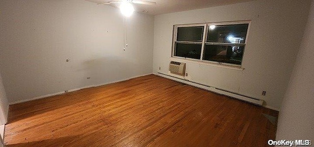 unfurnished room with a baseboard radiator, a wall unit AC, hardwood / wood-style flooring, and ceiling fan