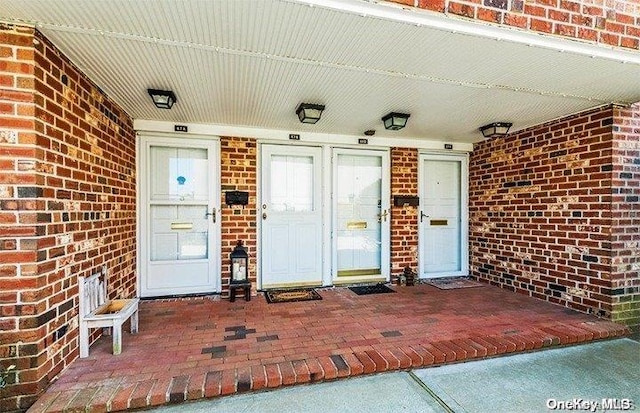 view of exterior entry featuring a porch