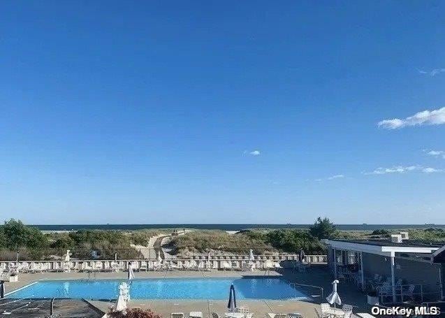 view of pool with a water view