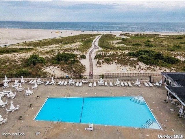 bird's eye view with a water view and a view of the beach