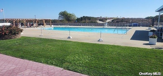 view of swimming pool featuring a yard and a patio