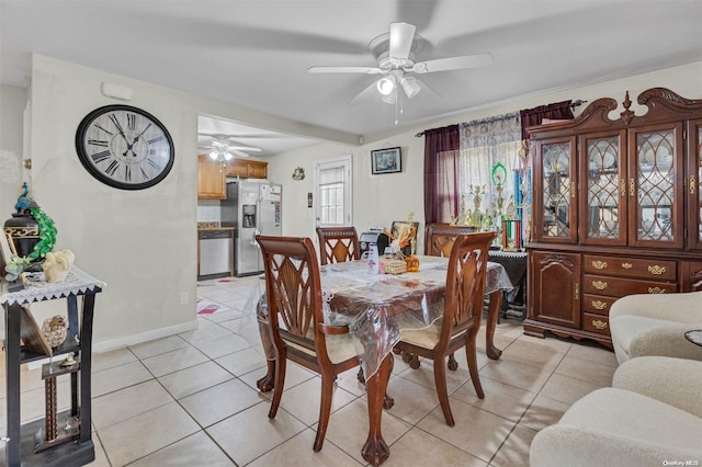 dining space with ceiling fan and light tile patterned flooring