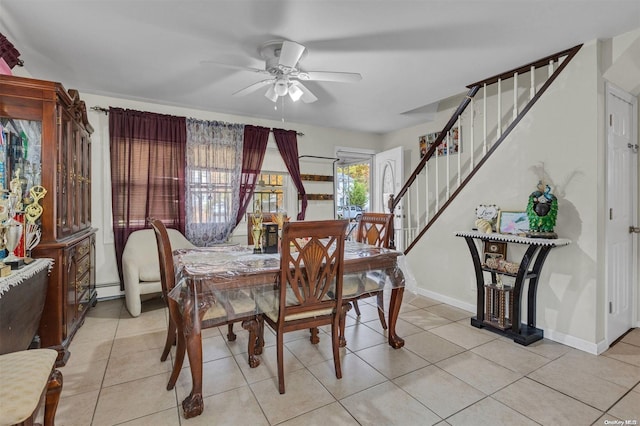 tiled dining area with ceiling fan and a baseboard radiator