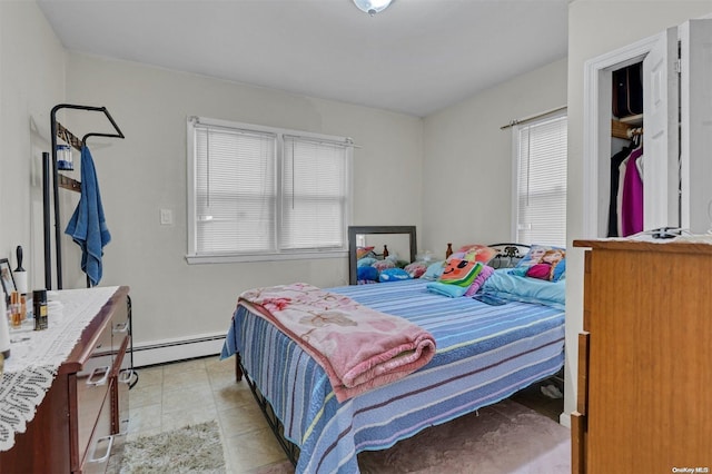 tiled bedroom with a baseboard heating unit