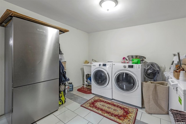 washroom featuring light tile patterned flooring and separate washer and dryer