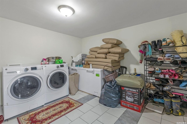 clothes washing area featuring washing machine and clothes dryer and light tile patterned floors