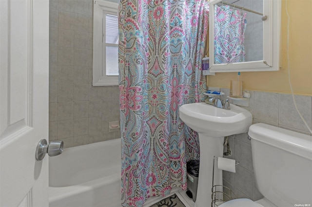 bathroom featuring shower / bathtub combination with curtain, tile walls, and toilet