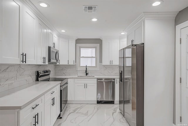 kitchen featuring white cabinets, backsplash, sink, and stainless steel appliances